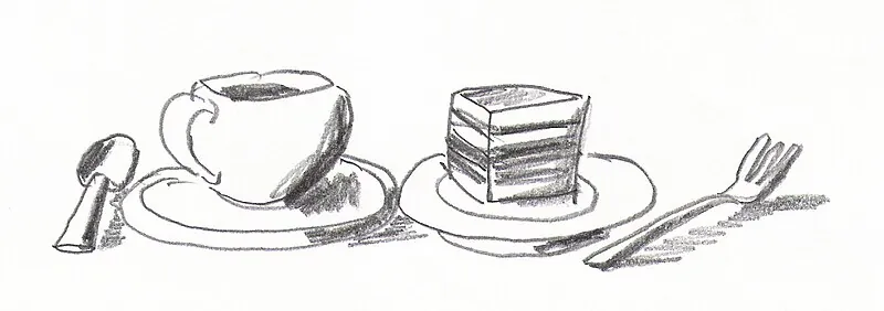 A table set with a pot of filter coffee, ceramic cups, and slices of cake in a German café